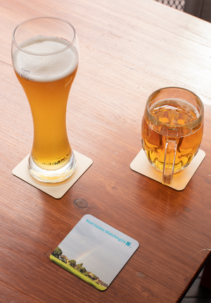 The Rainbow Sinari Cork-back coaster with Real Estate Matching Logo